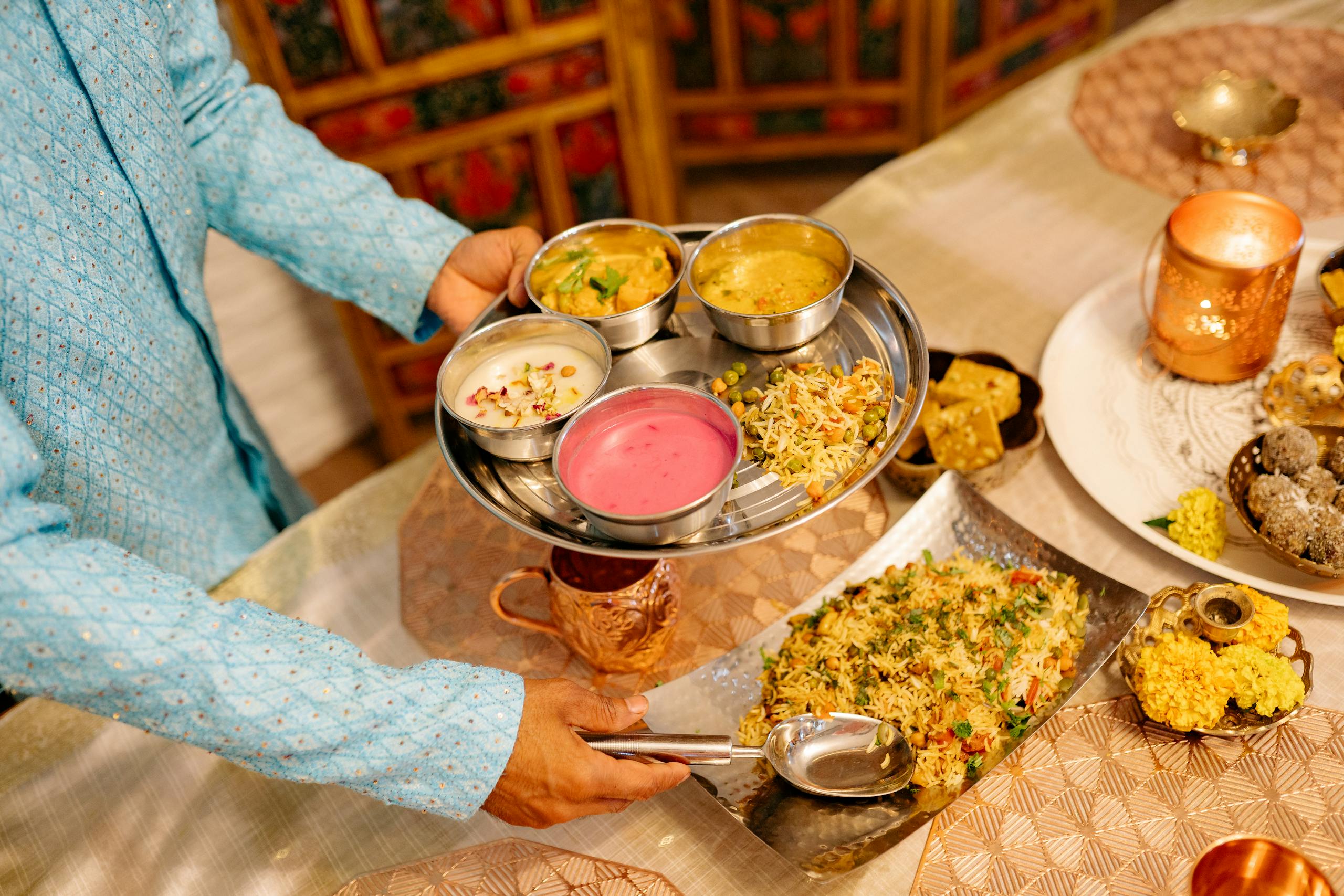 A Person Putting Food on the Stainless Plate